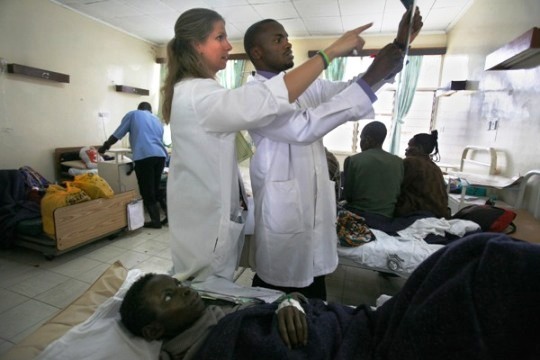 Doctors Nowiba Mugambi and Indiana Universtiy resident, Erica Palys, M.D. discuss a patient's x-ray at the general ward in Eldoret.